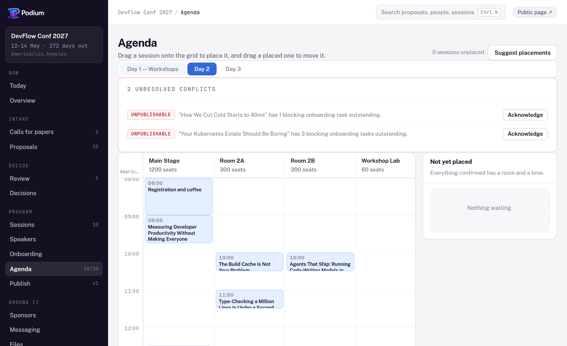 The agenda screen: a panel naming two conflicts that block publication, above a room-by-time grid with sessions placed across Main Stage, Room 2A, Room 2B and the Workshop Lab.